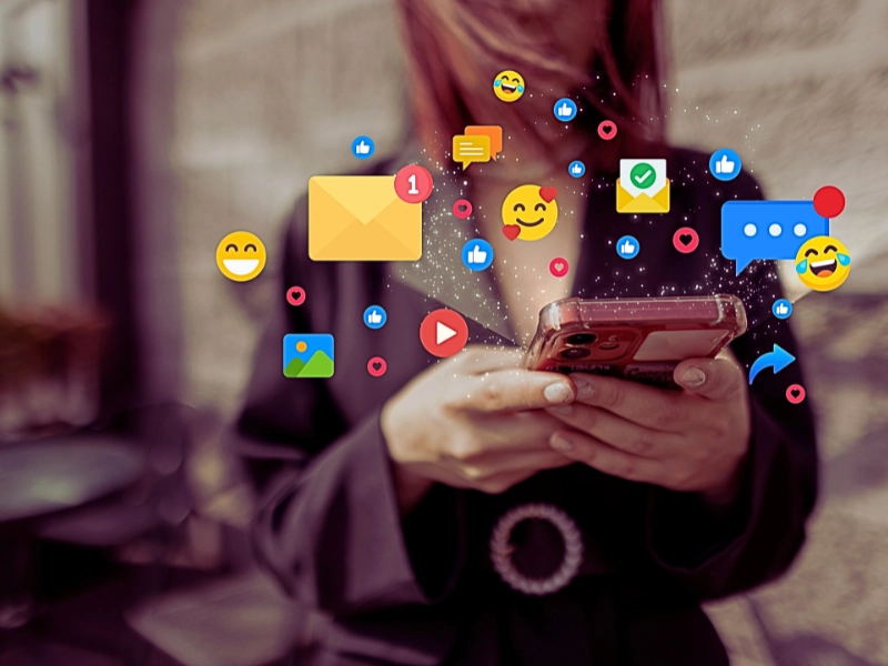 a young woman in a blazer holding a smartphone with both hands. Social Media Can Impact High-Asset Divorce