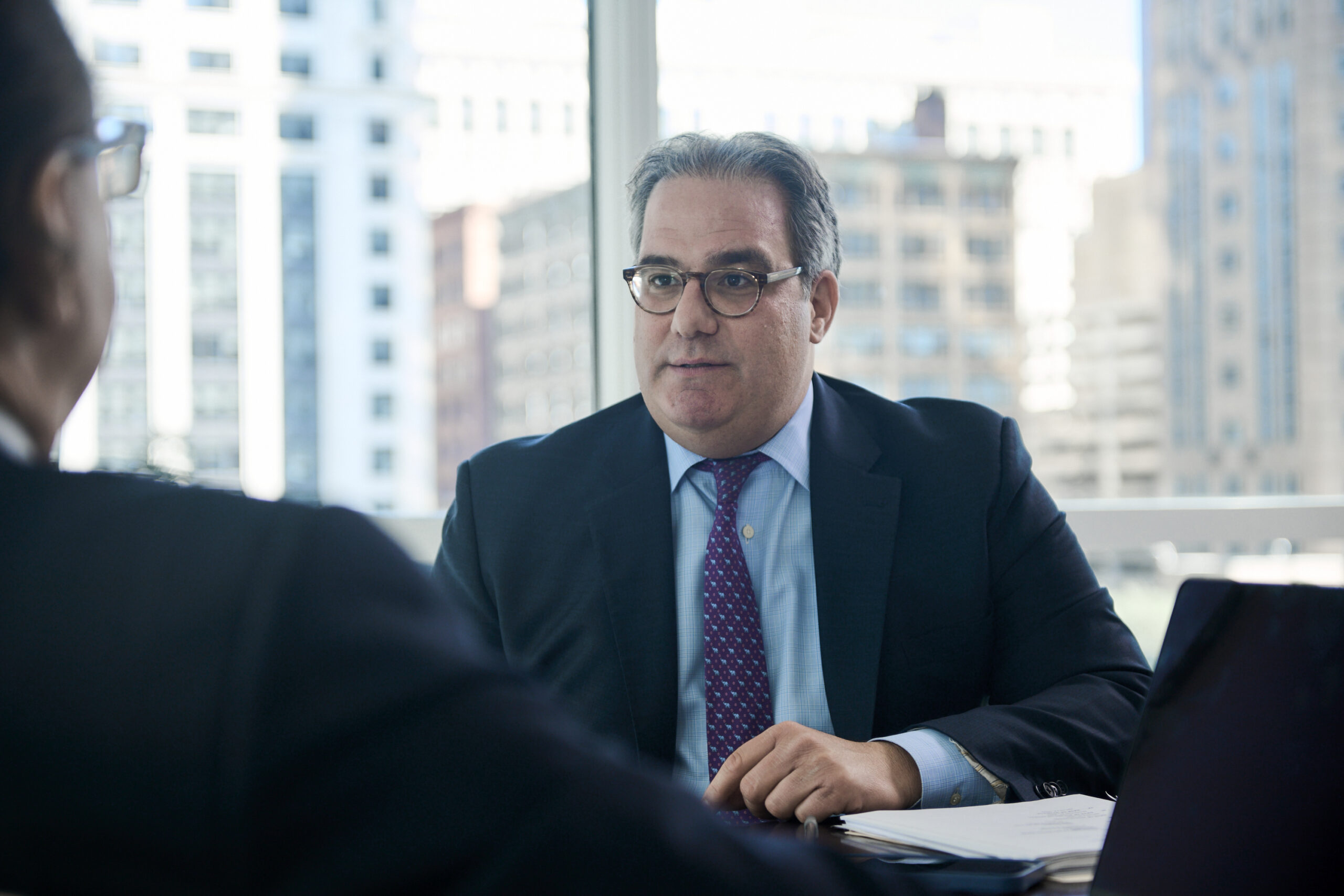 Northbrook High Asset Divorce Lawyer David Silberman sitting at desk talking to a client.