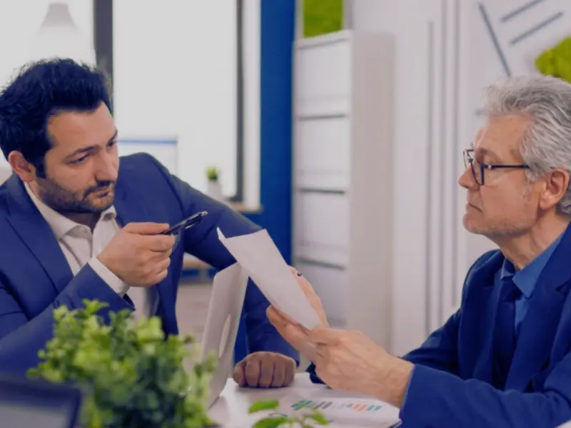 A lawyer assisting his client who is reviewing legal documents in the office professional practice considered marital property